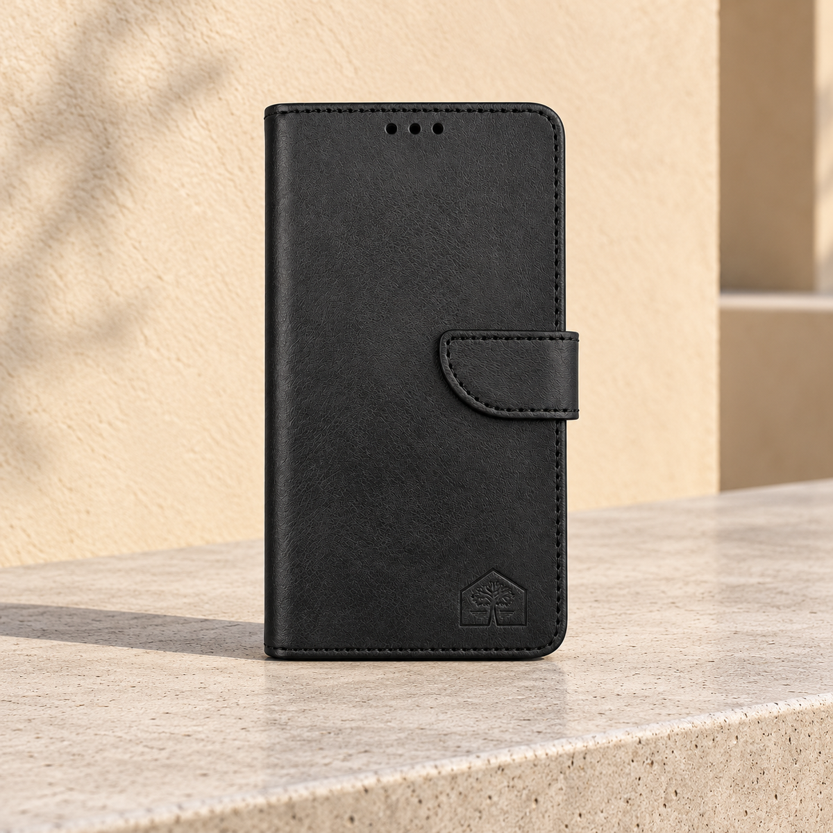 Black wallet phone case, closed front view, stone bench