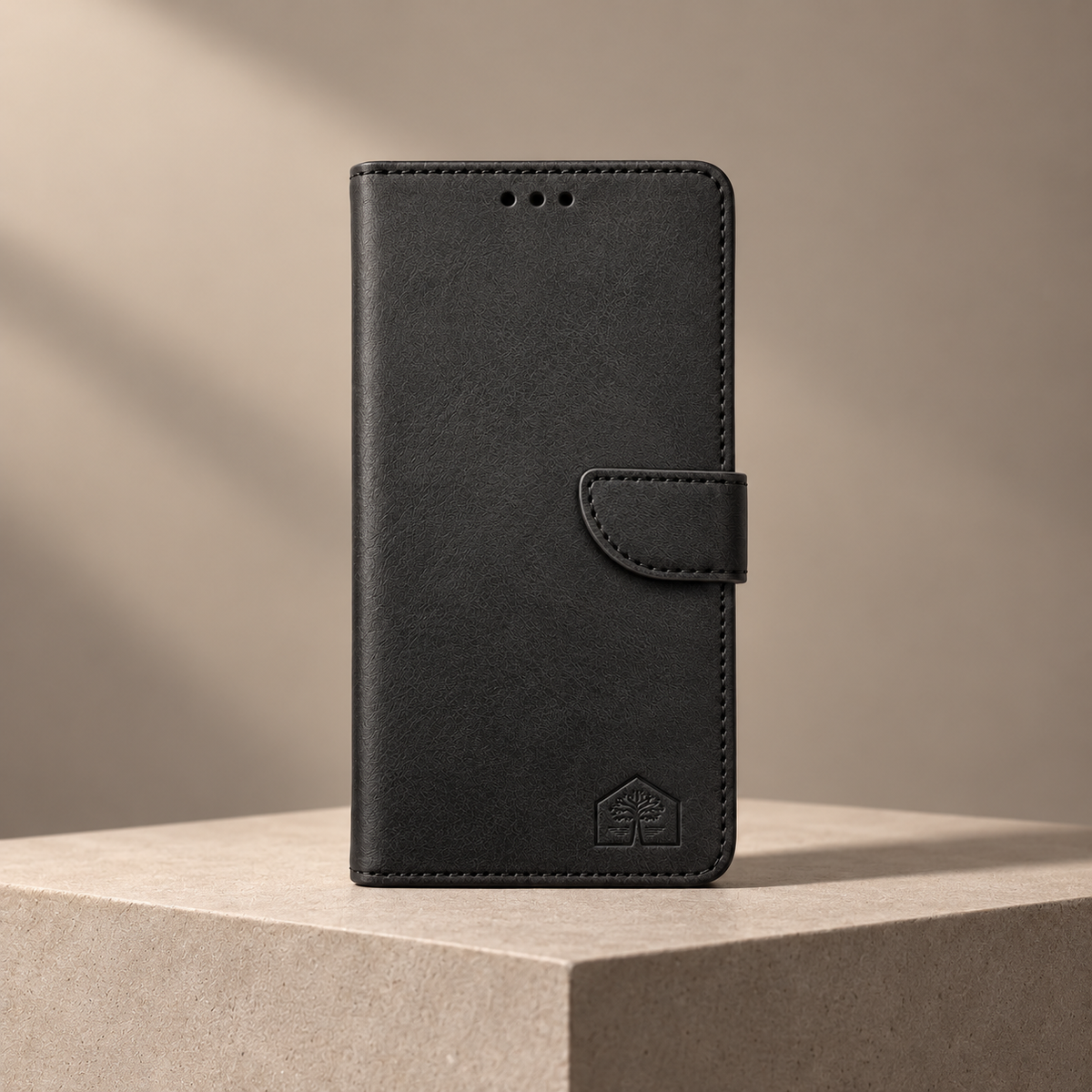 Black wallet phone case, closed front view, geometric plinth