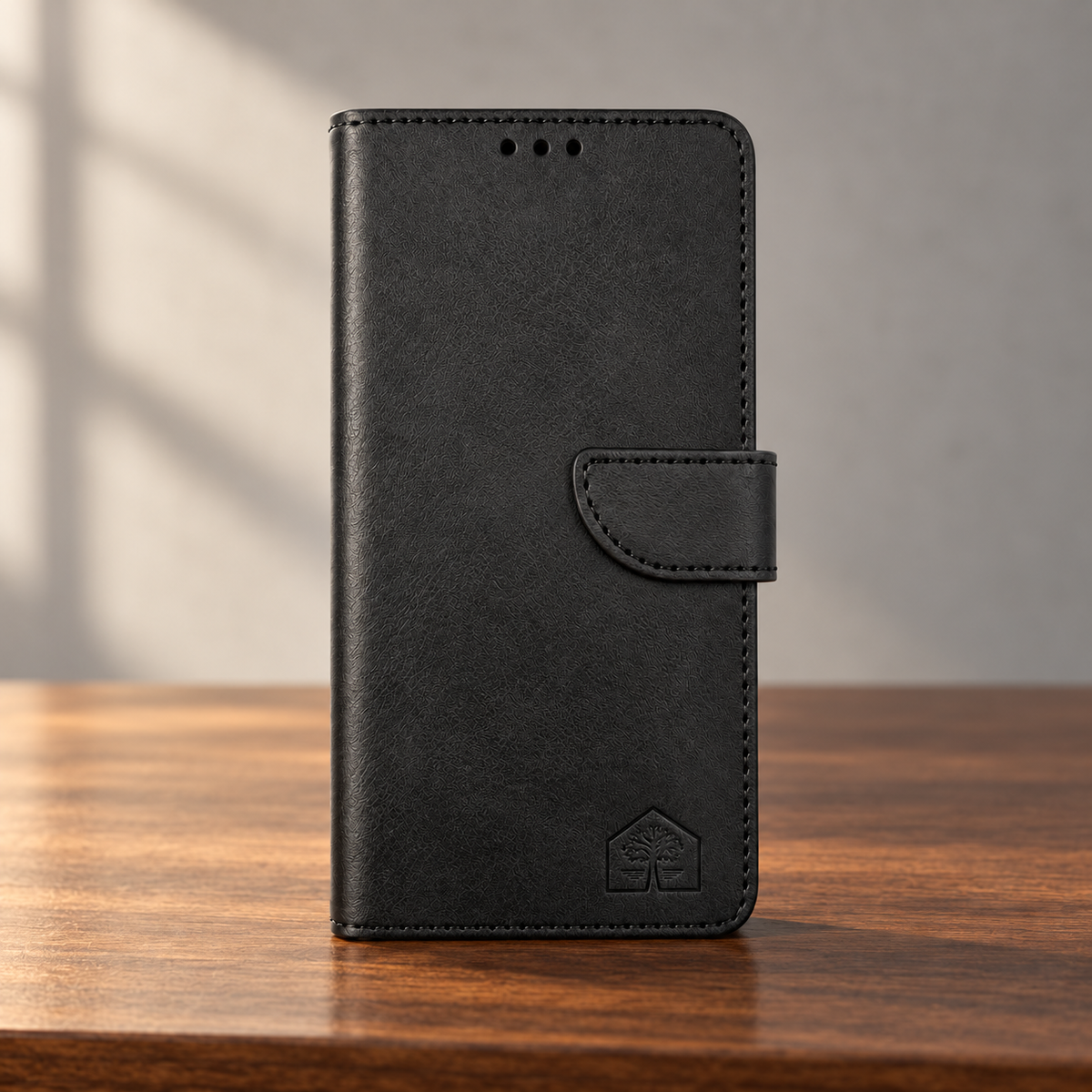 Black wallet phone case, closed front view, reading desk